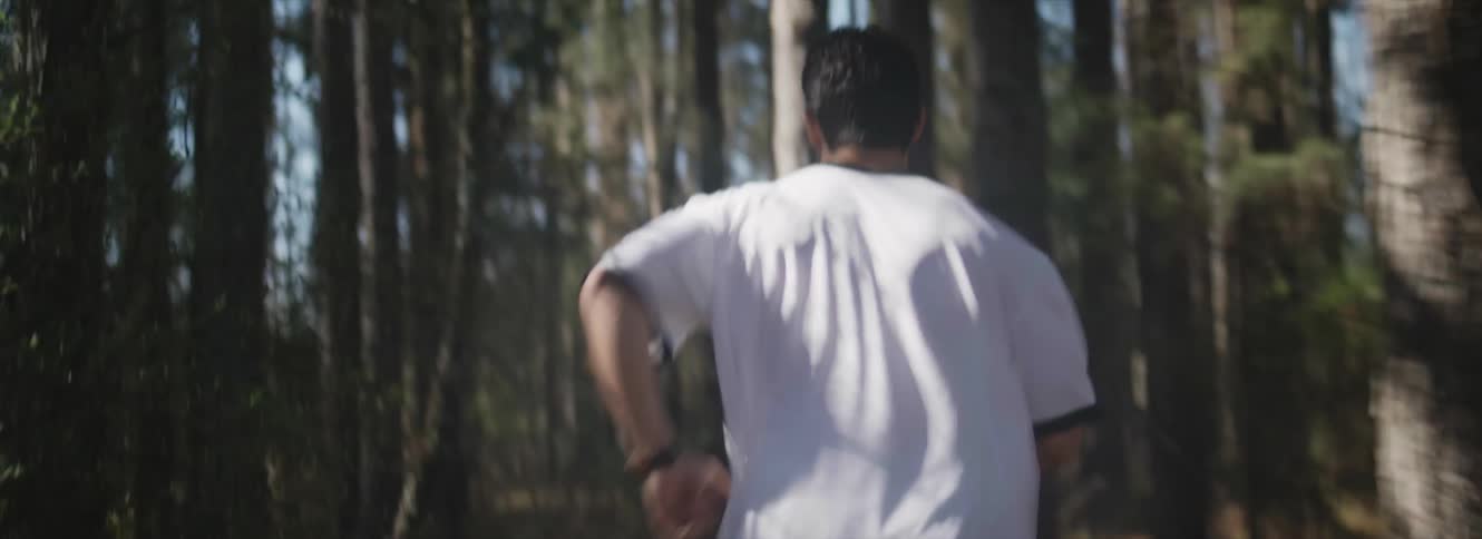 Man wearing white clothes running through the smoke in the forest
