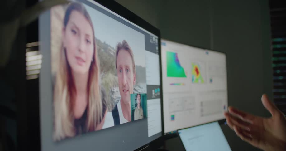 A man is video chatting with friends through a desktop computer