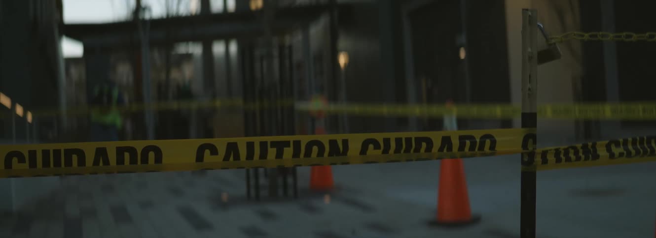 Yellow caution tape in front of the entrance of a building in the city