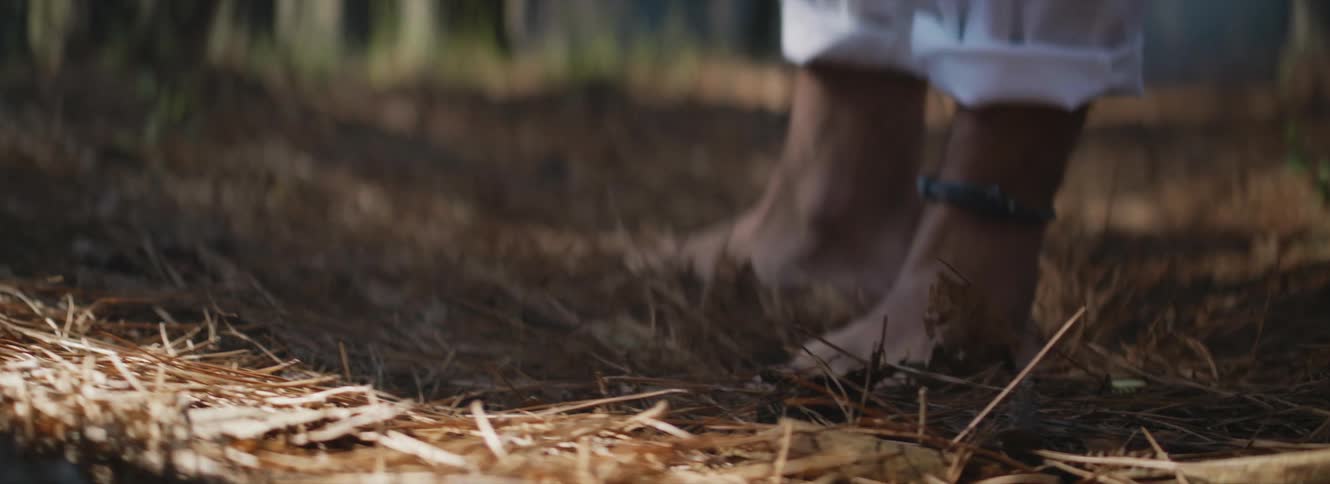 A person with focus on their feet getting up and walking