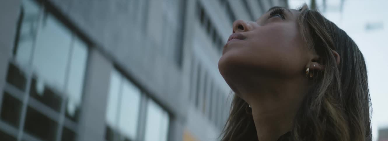 A woman standing outdoors looking up
