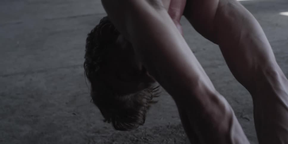 Man hangs upside down bound and gagged over concrete floor in empty building