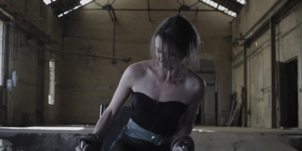 A woman who is gagged and duct taped to a chair falls over as she struggles
