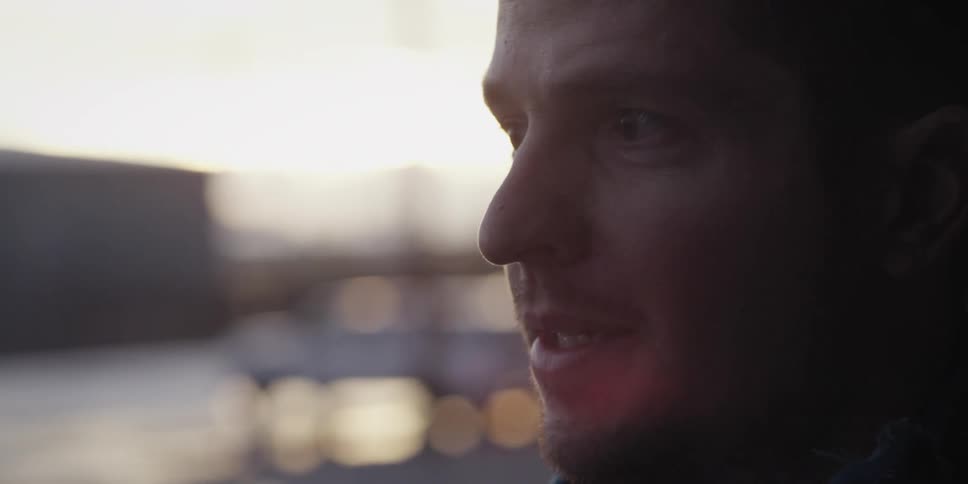 Face of a man talking and laughing at sunset