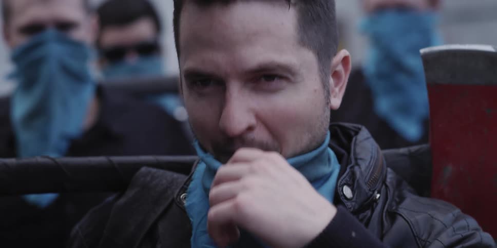 A man putting a bandanna on his face