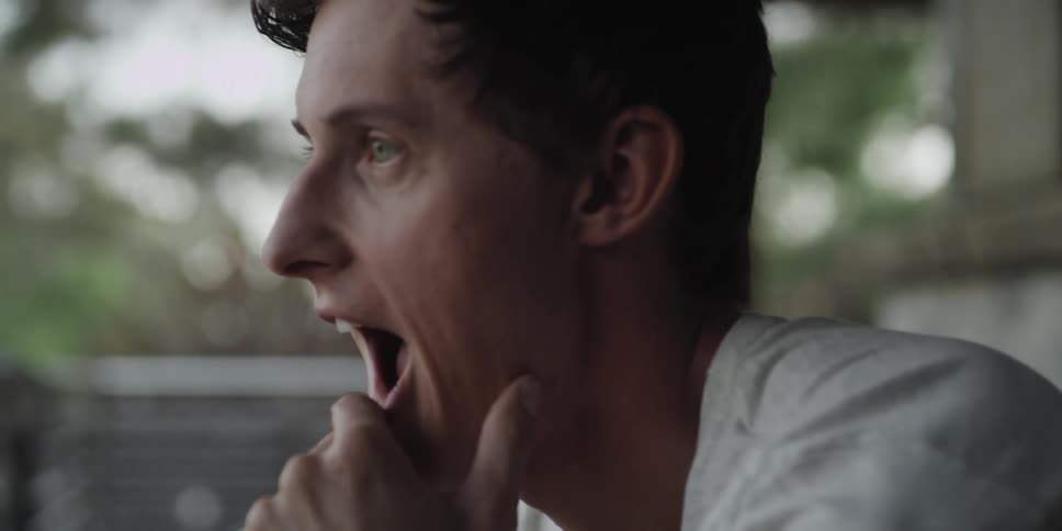 A man looks surprised as he rubs his chin