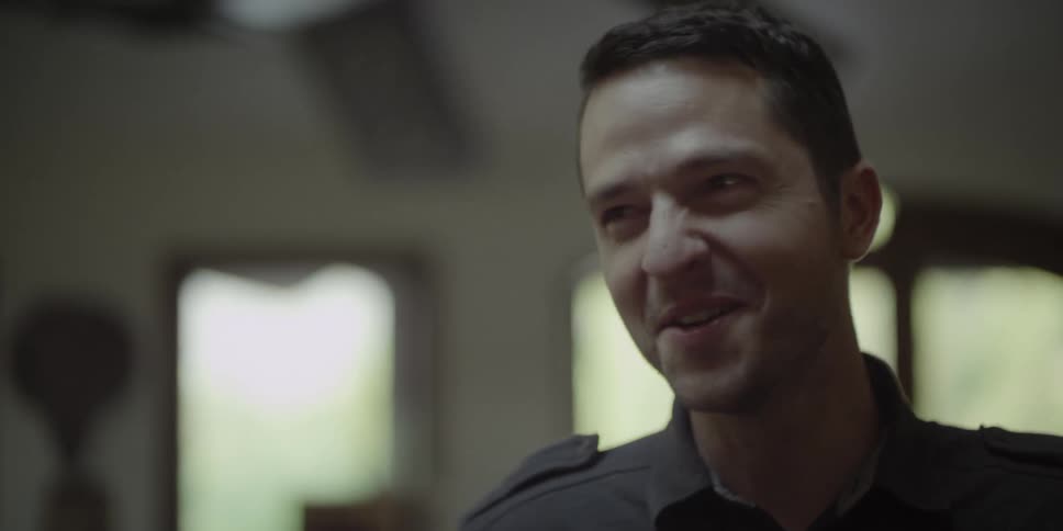 A male is talking and laughing in a room