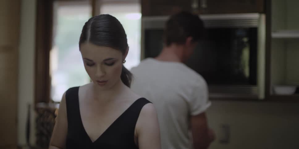 A man and woman cooking in a kitchen