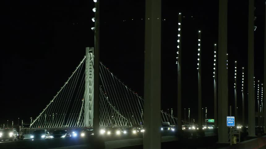 Heavy traffic crossing a bridge at night