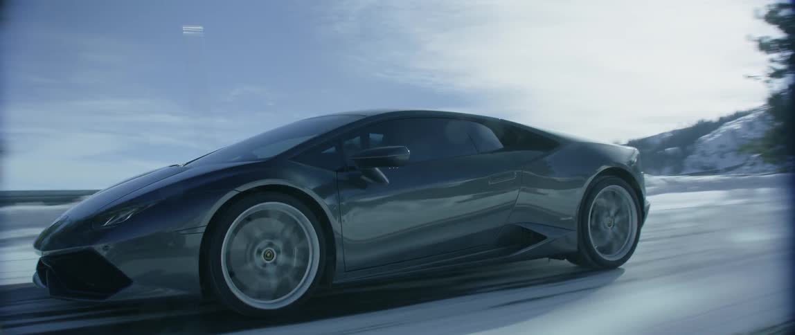 A car is traveling fast down a snow covered road