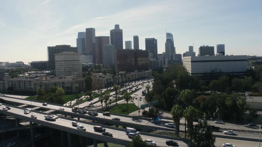 There is heavy traffic on a freeway just outside the downtown area of a large city
