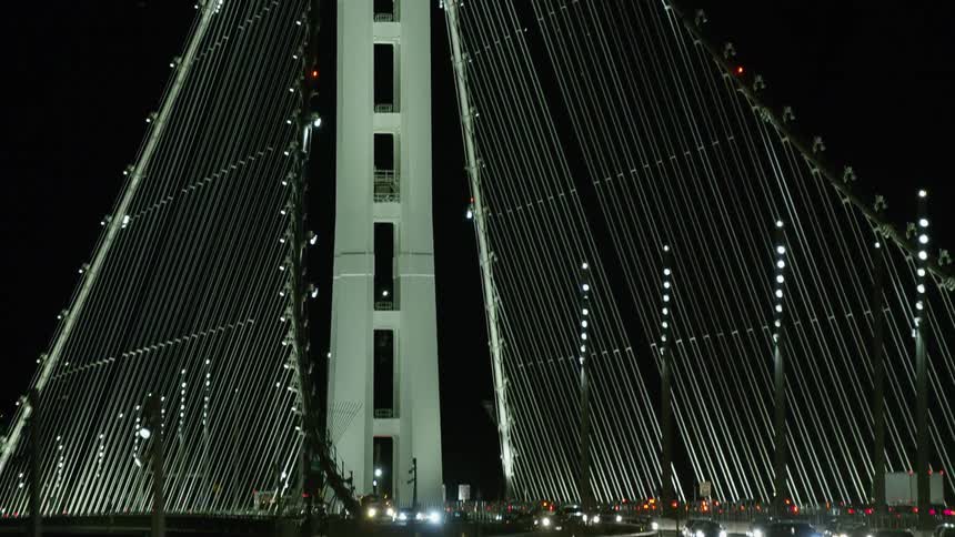 Dense traffic over a suspension bridge at night