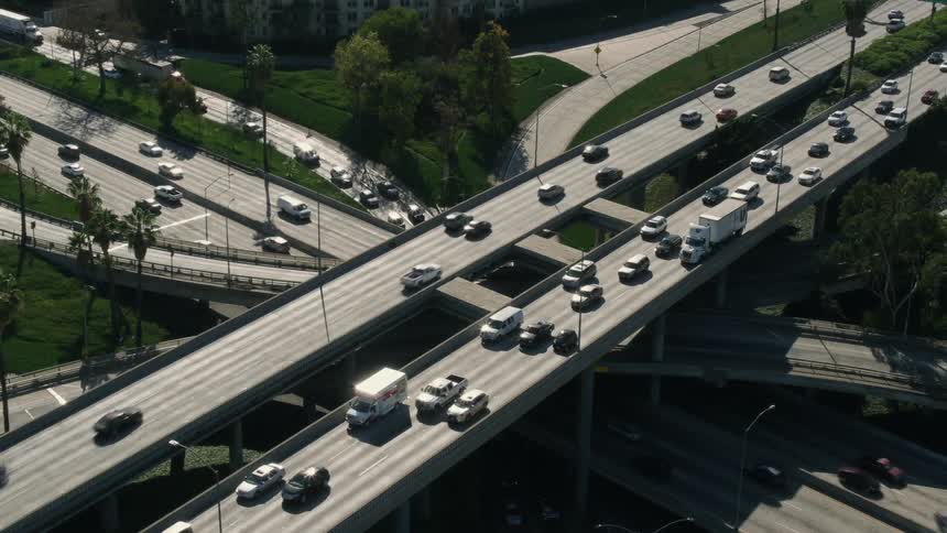 Aerial view of cars and trucks driving on grade separated junctions and highways