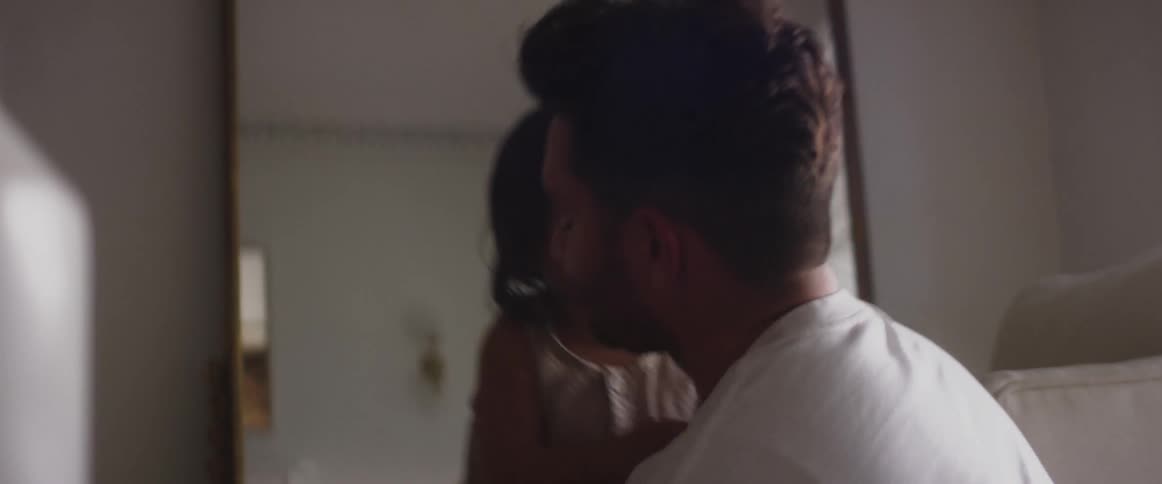 A man plays with his child in the living room