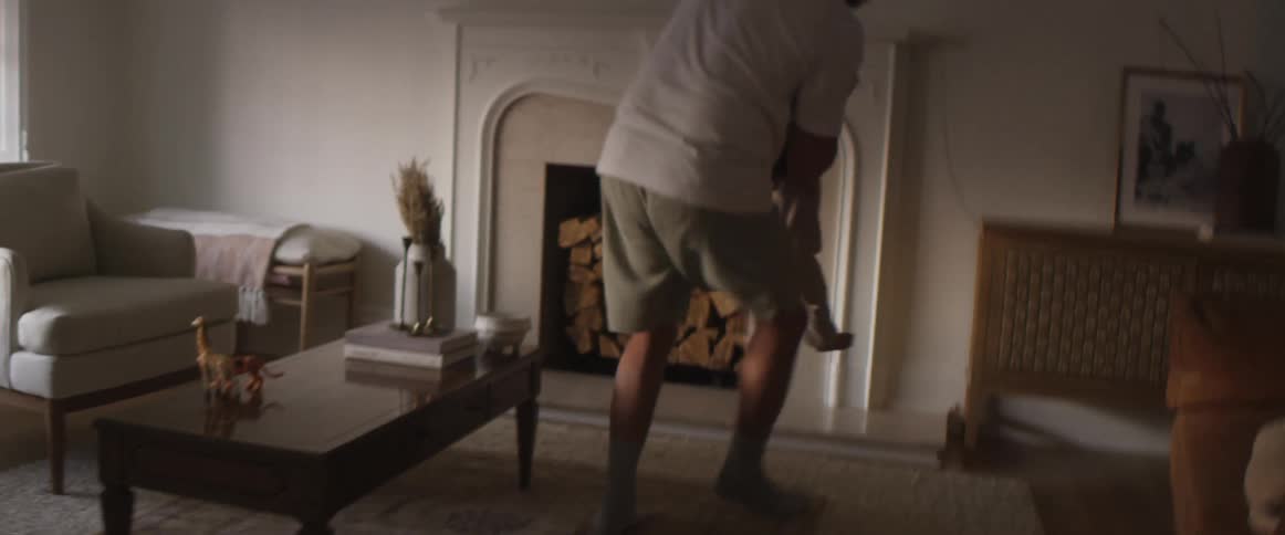 Father playing with his child in the living room