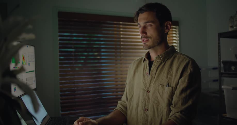 A man standing and talking in a room