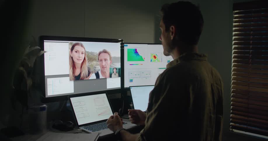 A man talking to two people through a video call