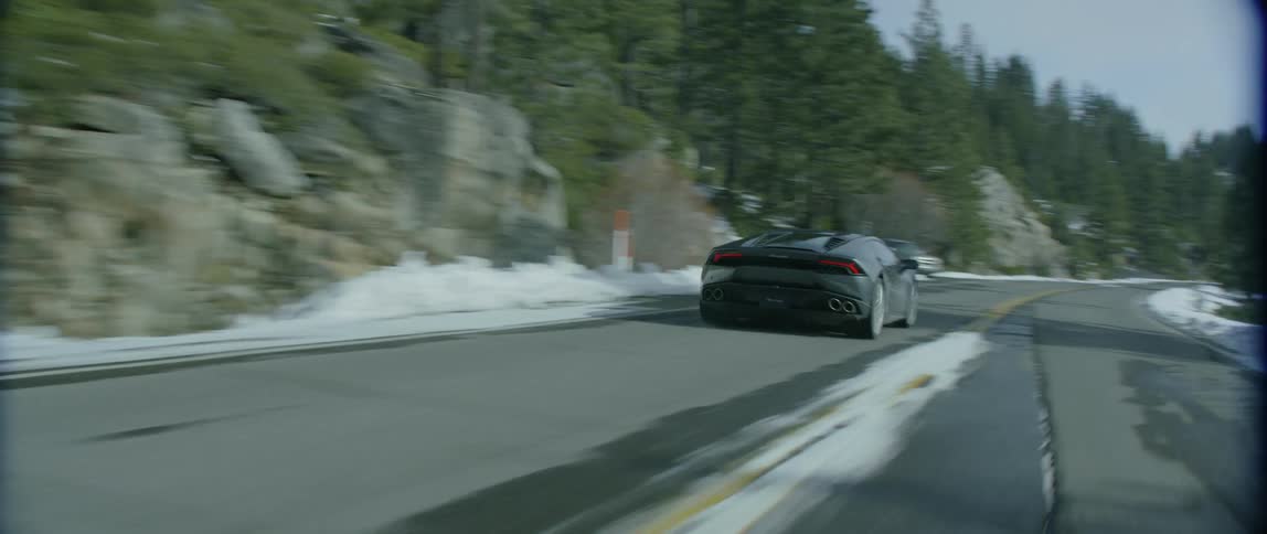 A car races off into the distance on a small road