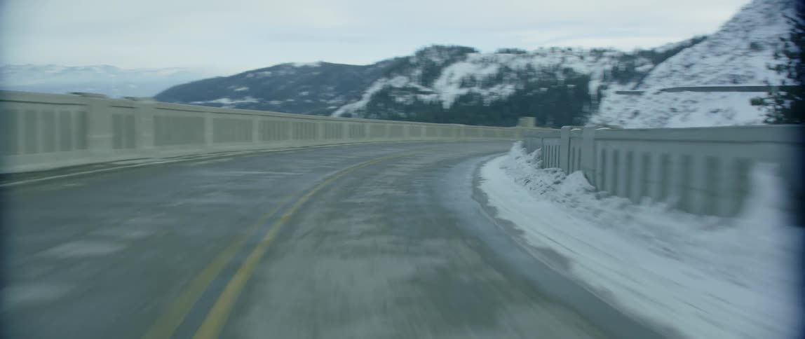 Turning on a twisting road with a cliff on both sides