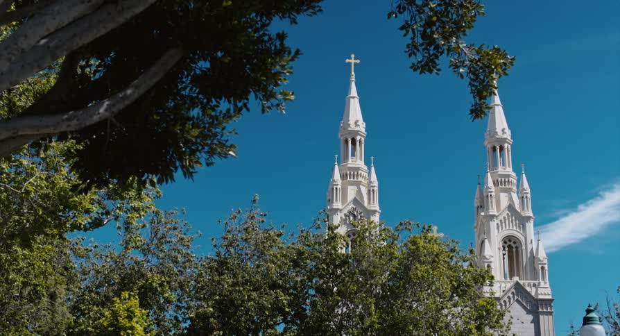 The tall church has a cross at the top