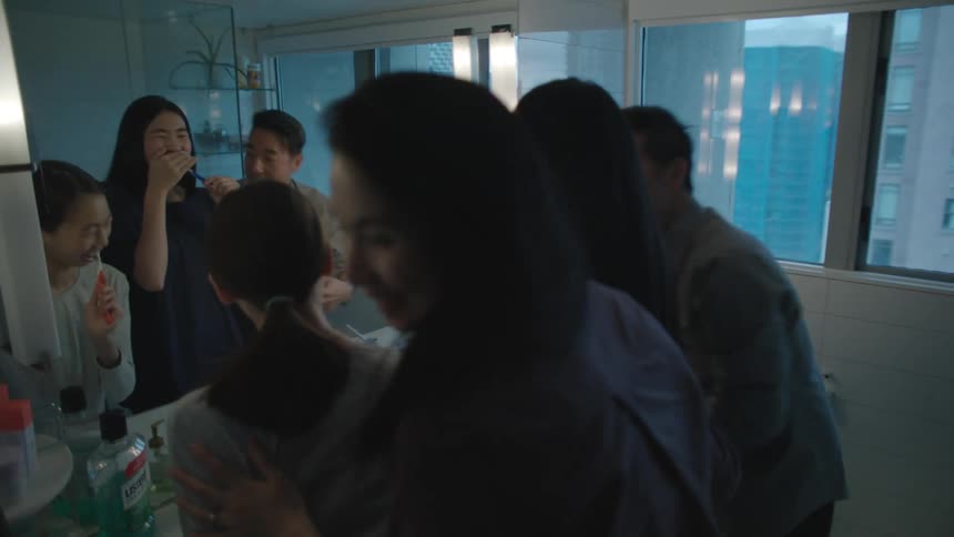 Family brushing their teeth toghether in the shared batroom at home