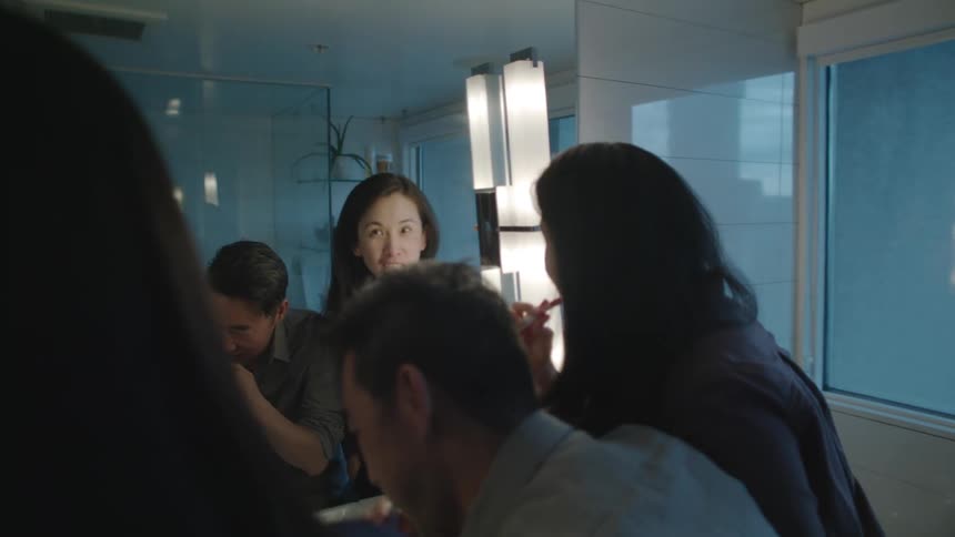Family brushes their teeth standing in bathroom together