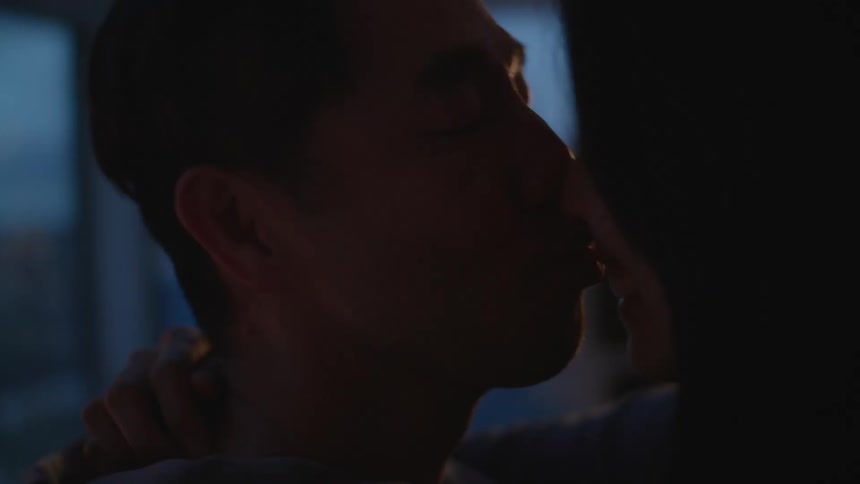 Couple smiles and kisses as they hug