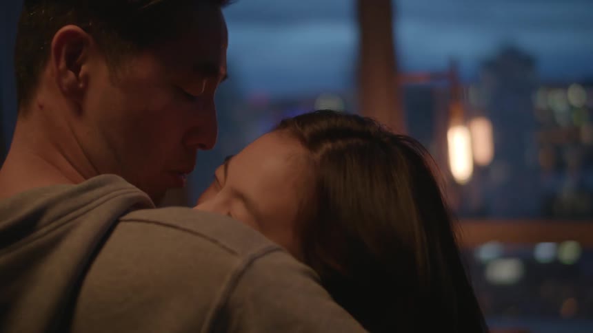 A man and woman are dancing and hugging