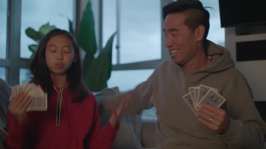 Family plays card game and daughter protests fathers move