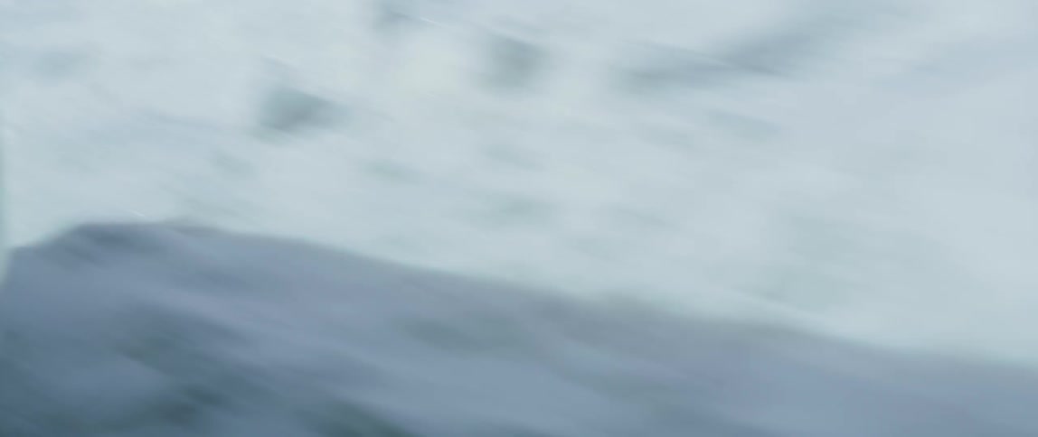 Close up of a car as it moves down a road