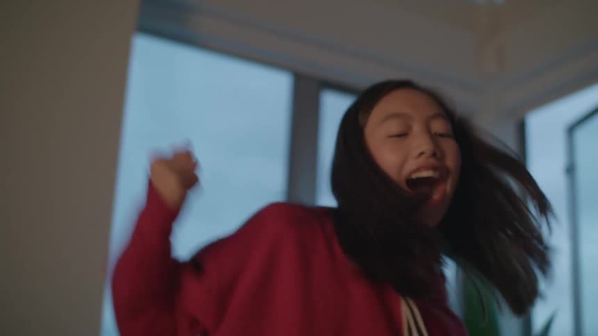 Girl celebrates winning at a tabletop game with her family at home