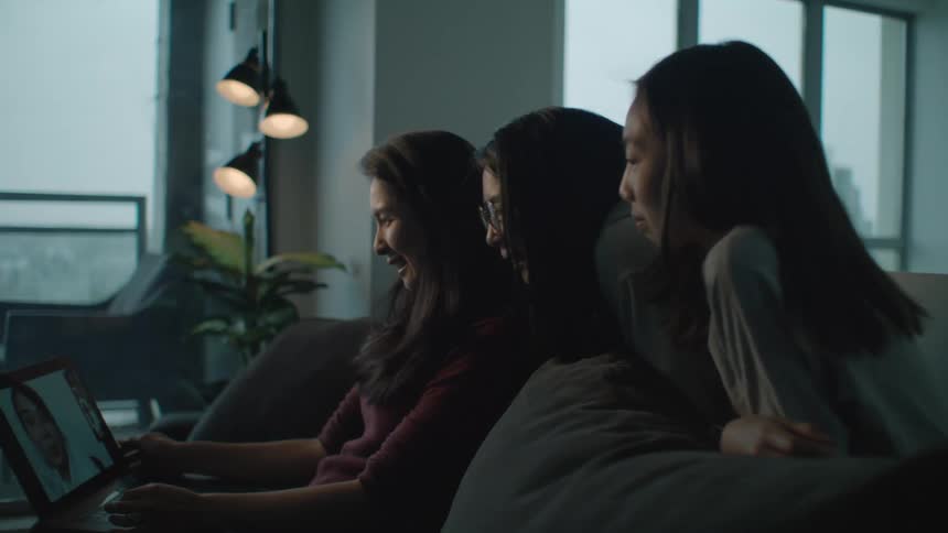 A family talk to someone on a video call
