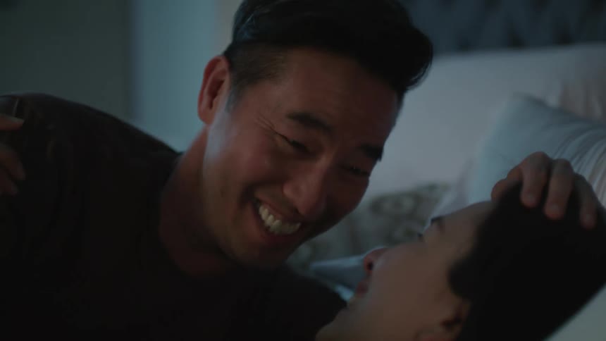 Husband kisses his wife on the forehead