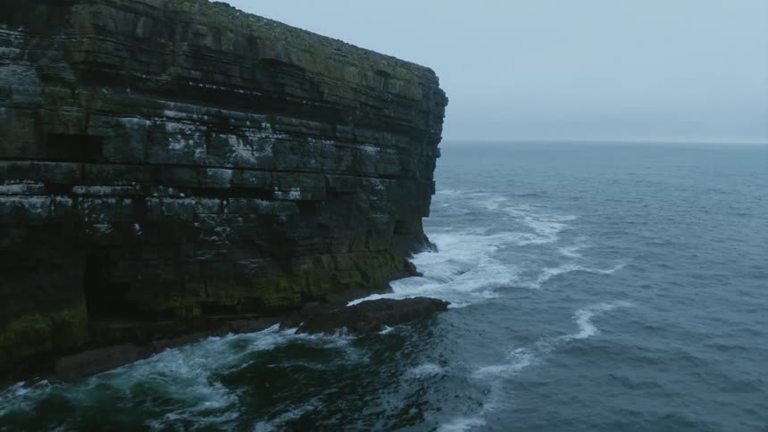 A rocky coast with the ocean in the background