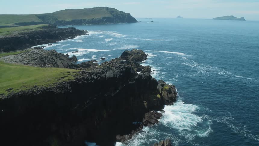 Ocean waves roll into shore near the rocks