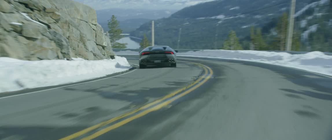 A sports car drives in the snowy mountains