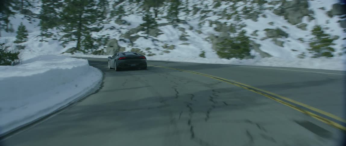 A sports car switches lanes as it makes a tight turn