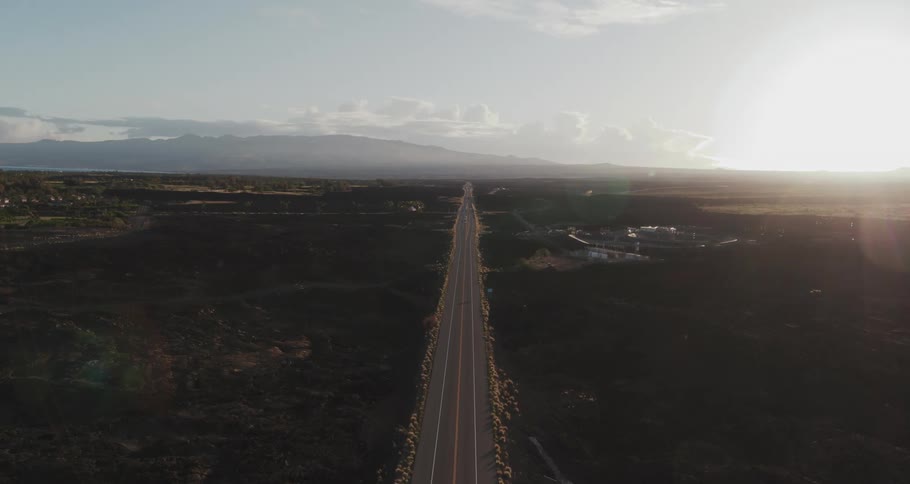 A long empty stretch of road runs to the horizon
