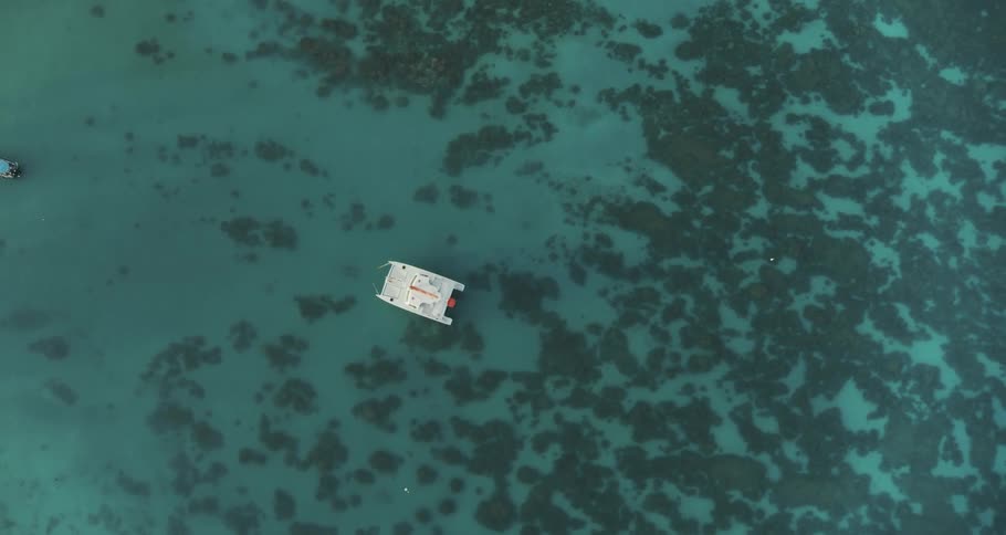 Aerial view of white boat on turquoise water