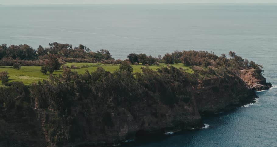 A headland on the ocean during the day
