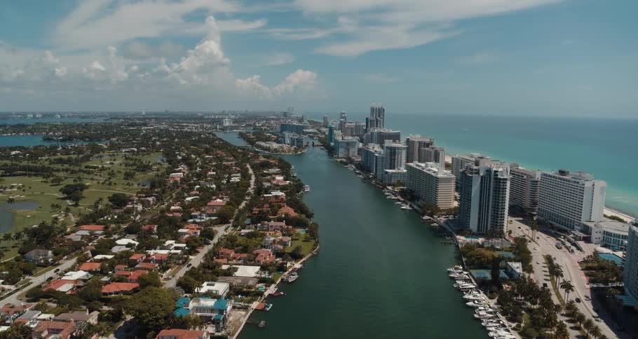 A river through a metropolis on the coast during the day
