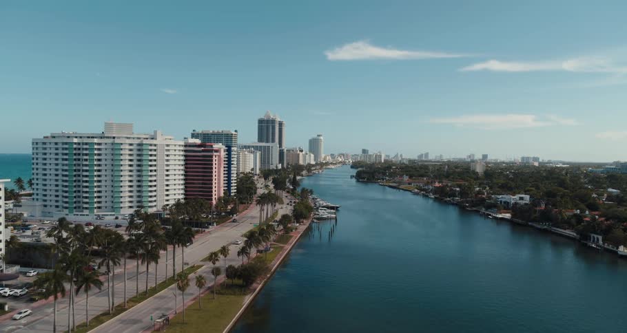 Aerial view of a downtown city near a marina is displayed