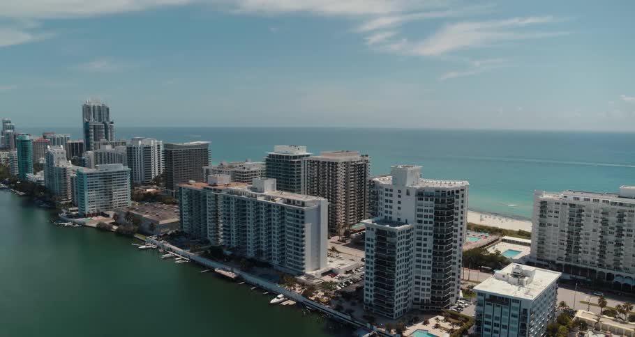 Aerial view of buildings on a narrow strip of land in front of the ocean