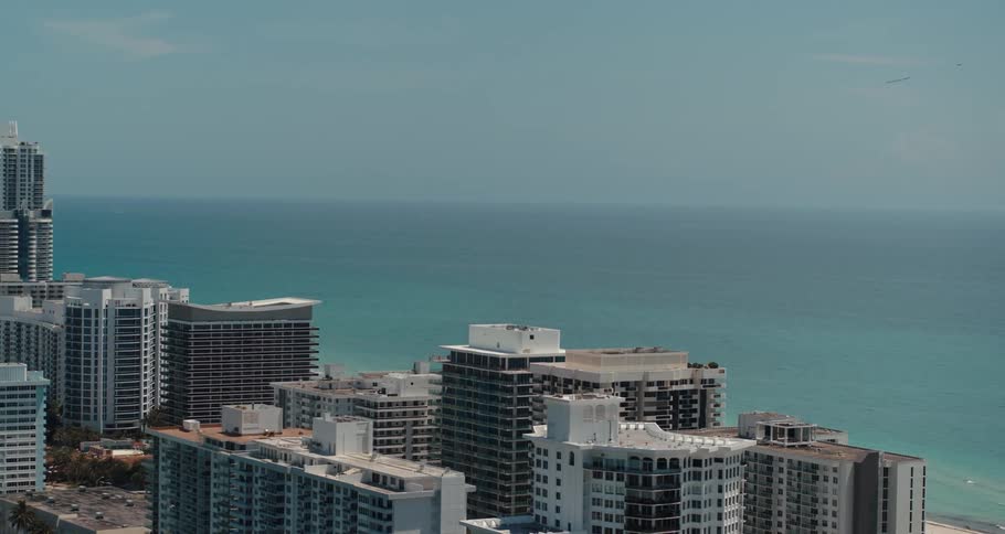 Aerial view of coastal city with apartments next to sea