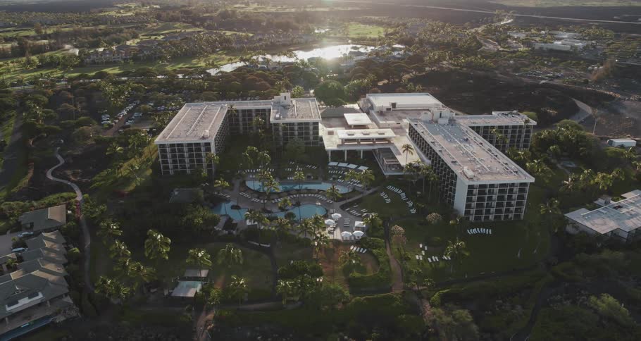 Aerial view of luxurious hotel with swimming pools and palm trees