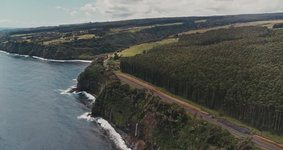 A road running along a cliff over the ocean during the day