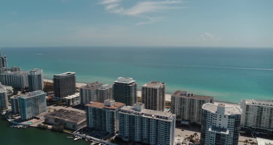 Buildings on a narrow strip of land in a metropolis on the coast during the day