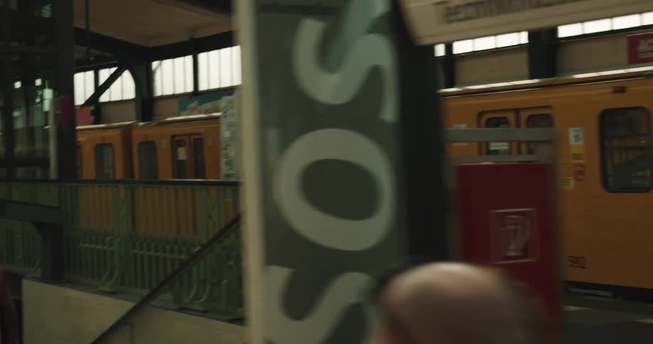 Young woman with short red hair gets off a train and exits the station