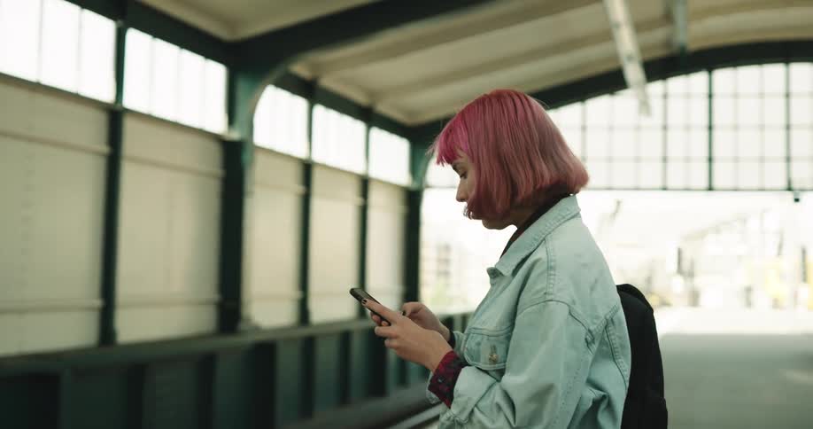 A woman is waiting for a train
