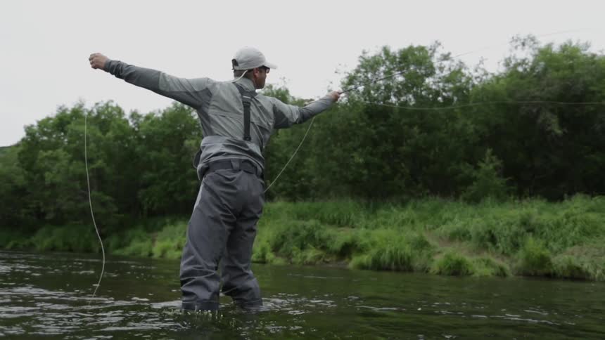 A man fishes in a river